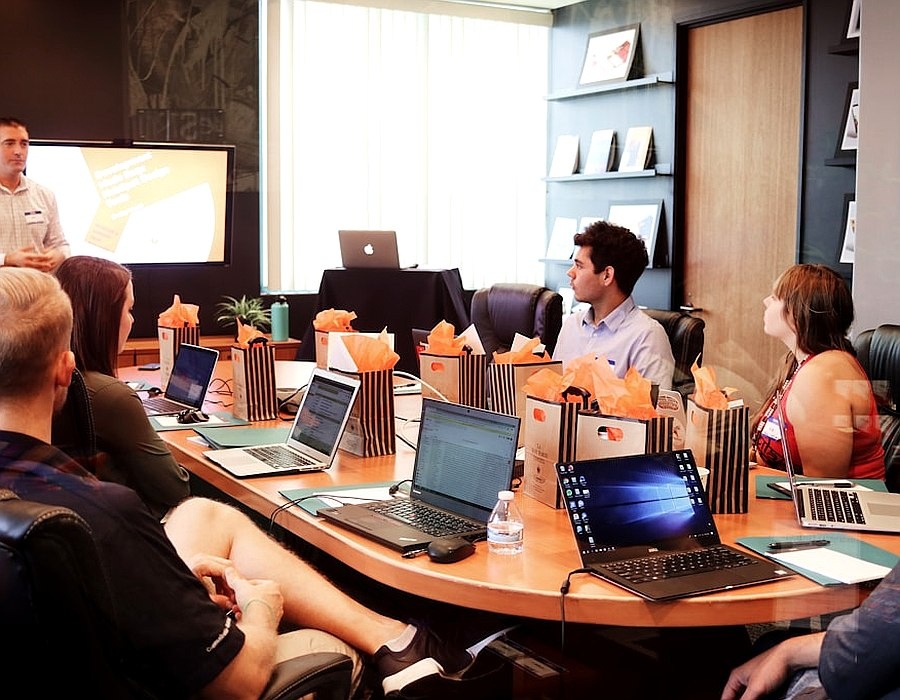 Milkos editorial meeting around a printed portfolio review
